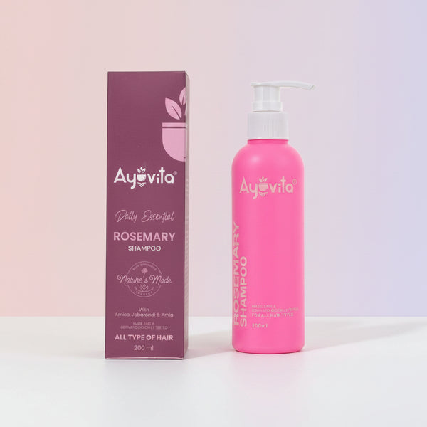 Pink shampoo bottle with Ayuvita branding next to its packaging on a white background